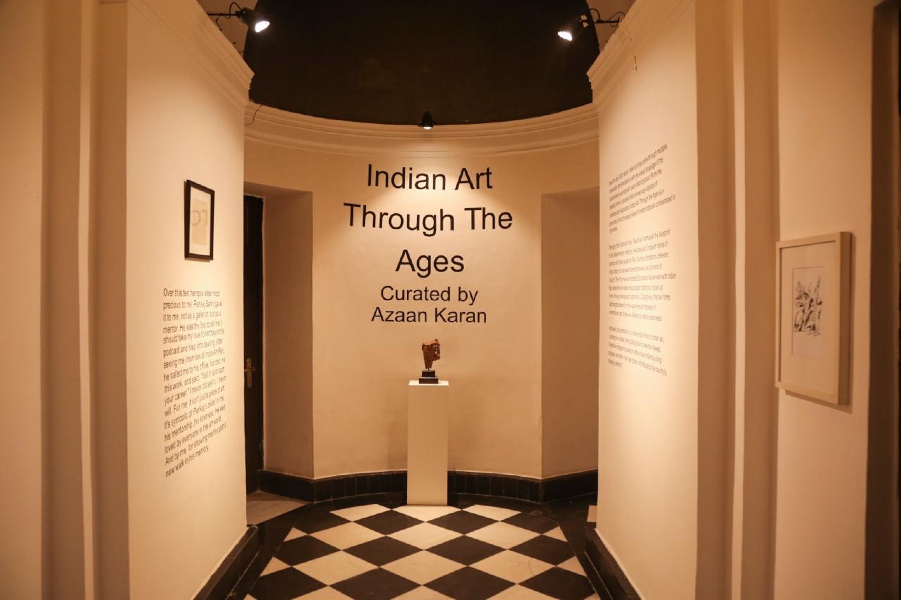 The rotunda of Indian Art Through the Ages: the title wall and a sandstone fragment on a plinth.