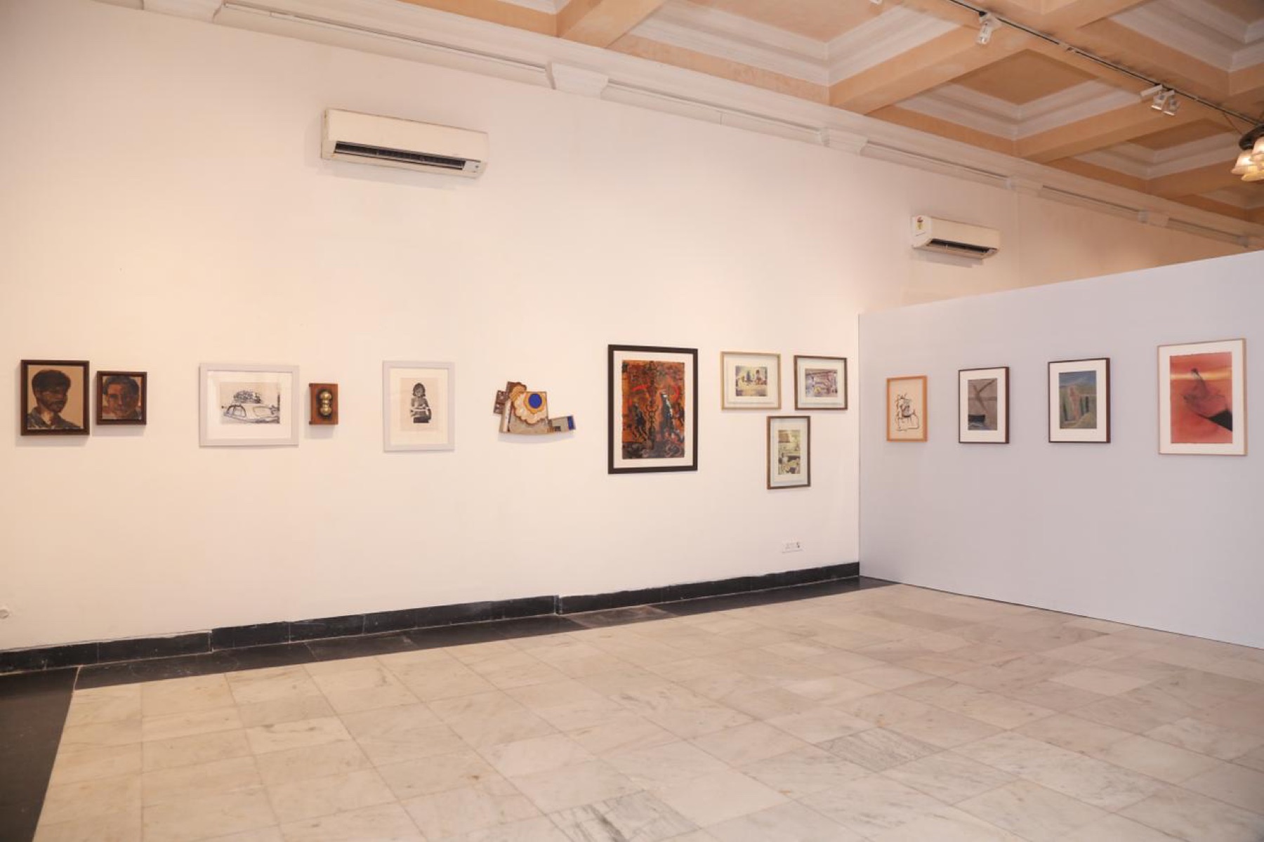 The modernist wall: portraits, assemblage, and paintings in a long line.